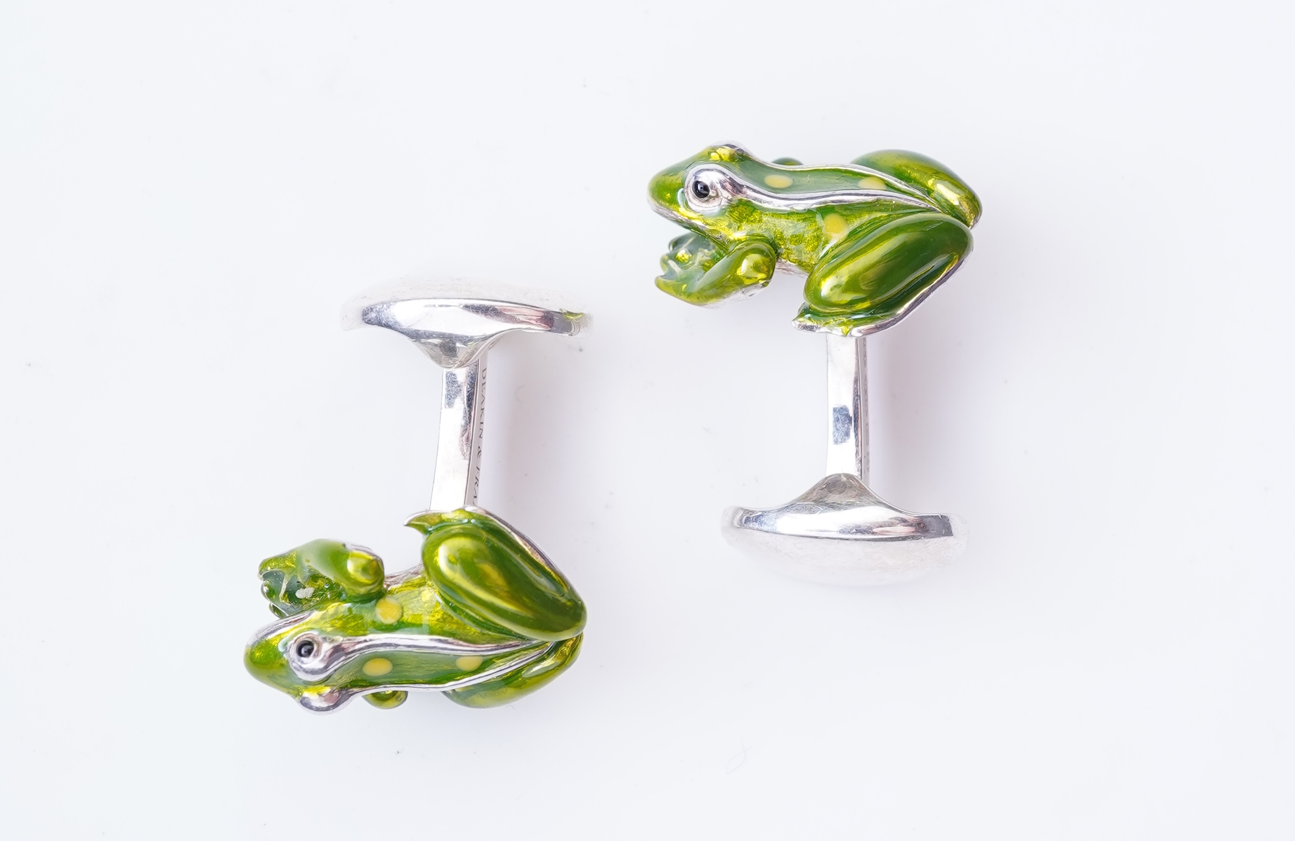 A modern pair of silver and polychrome enamel set oval cufflinks, 18mm.